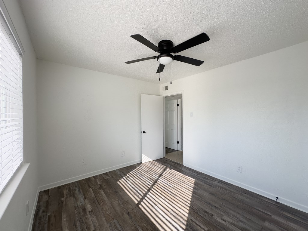 the living room of our studio apartment atrium with a ceiling fan