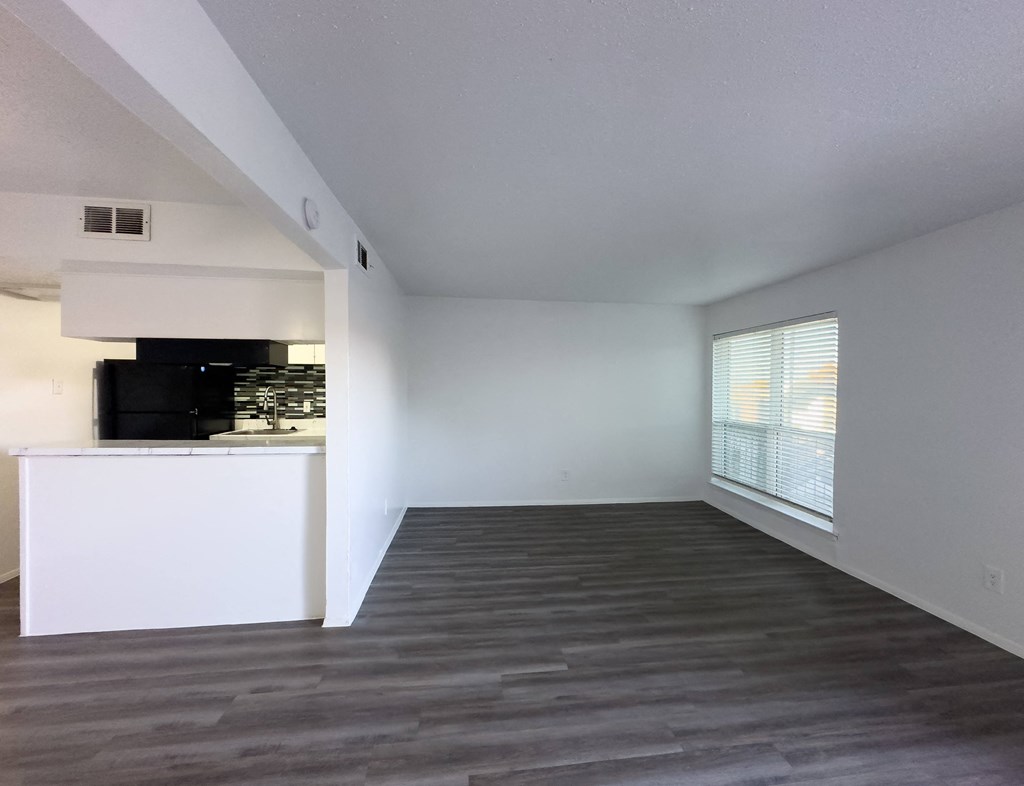 A spacious room with a white cabinet and a television.