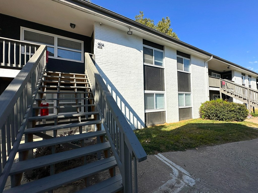 an exterior view of a building with wooden stairs