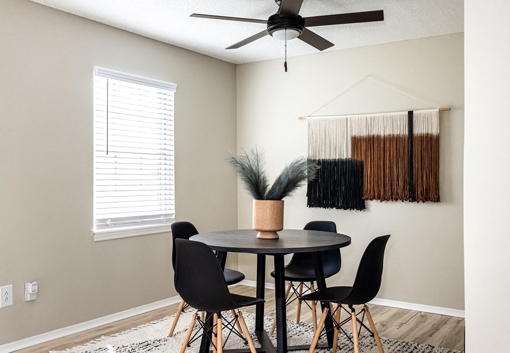 a dining room with a table and four chairs