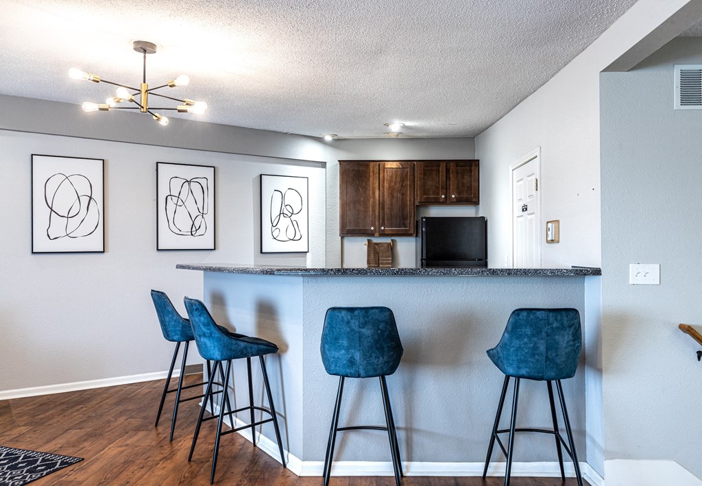 a kitchen with a breakfast bar and stools
