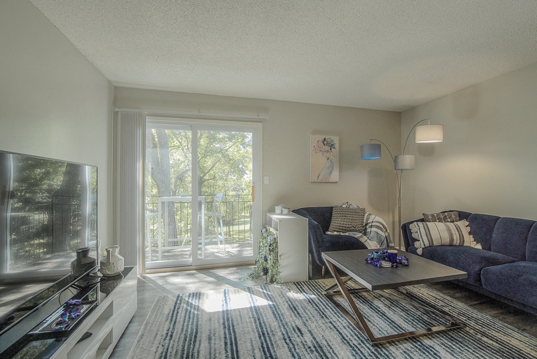 Photo of furnished room with door to balcony.