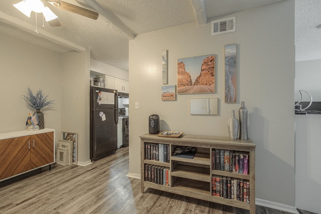 Picture of furnished room and hallway with vinyl flooring.