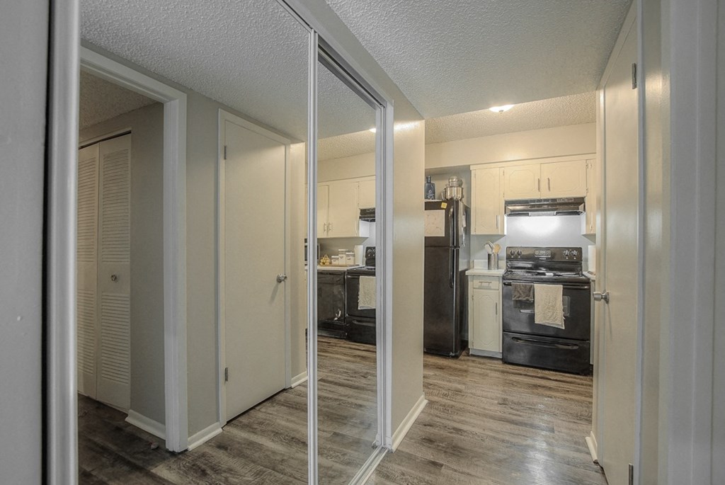 Photo of kitchen with white cabinetry and stainless steel appliances.