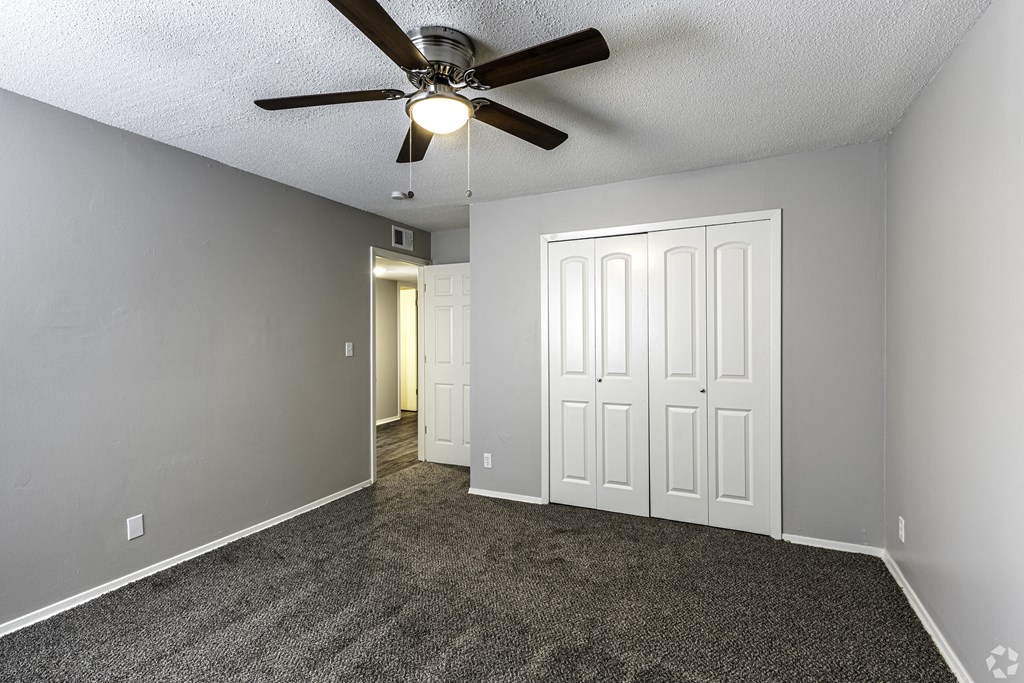 Photo of bedroom with vinyl flooring and ceiling fan.