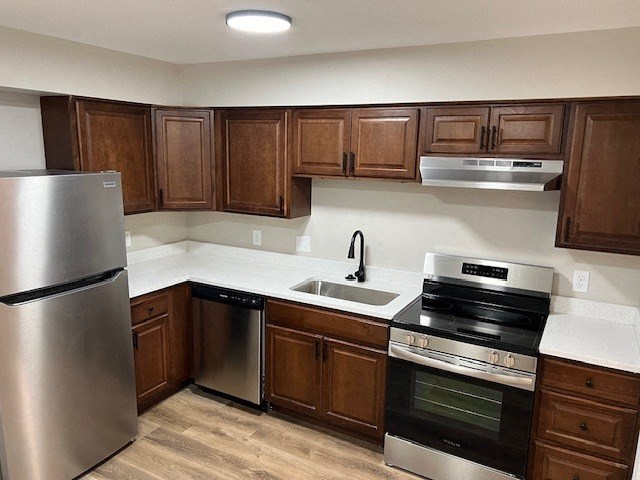 a kitchen with stainless steel appliances and wooden cabinets
