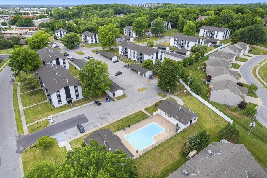 an aerial view of a neighborhood with houses and a swimming pool