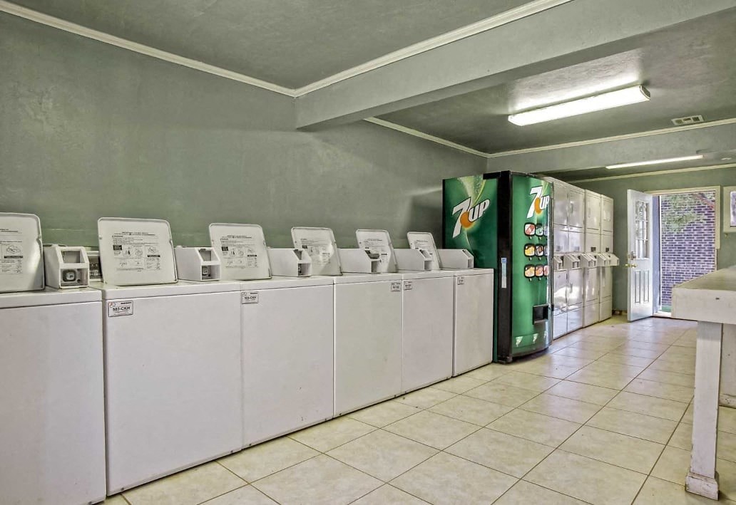 Image of washers and vending machines in community laundry facilities  at Residences at Lakeshore Apartments, Oklahoma City, Oklahoma