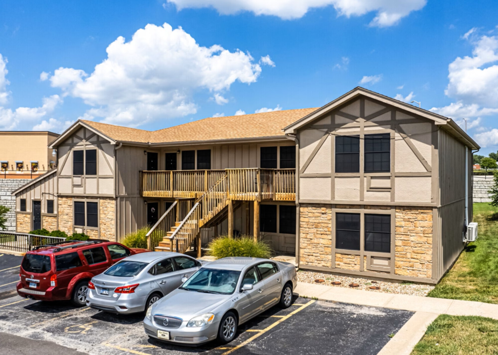 an apartment building with cars parked in front of it