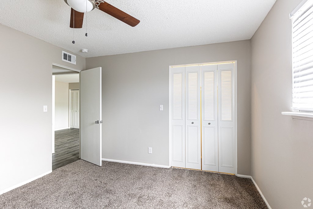 bedroom with closet ceiling fan and carpet in kansas city