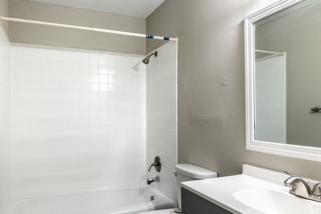 bathroom with large vanity and mirror and tub in kansas city