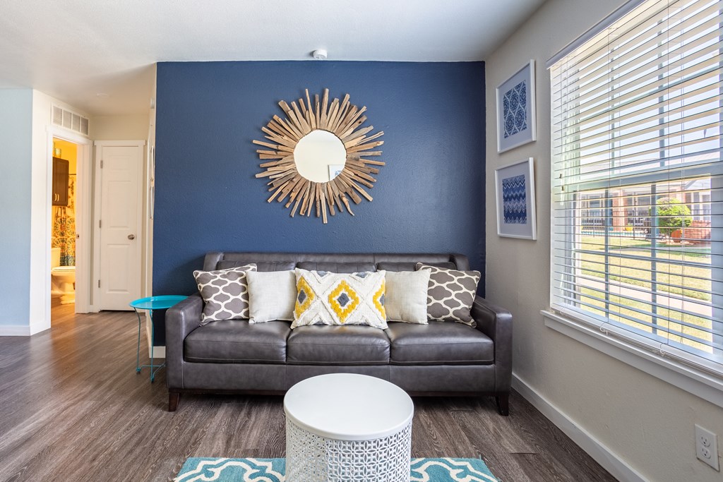 Couch and mirror in living room  at Bennett Ridge Apartments, Oklahoma City, Oklahoma