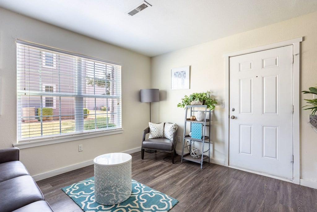 Chair with shelf and plant in living room  at Bennett Ridge Apartments, Oklahoma City, OK