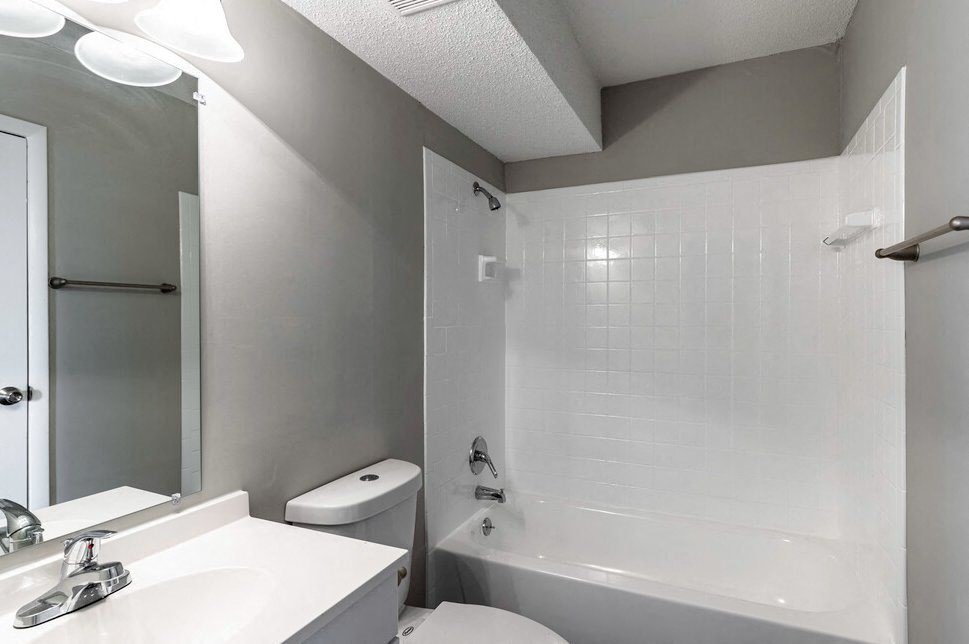 a bathroom with a sink toilet and a tub