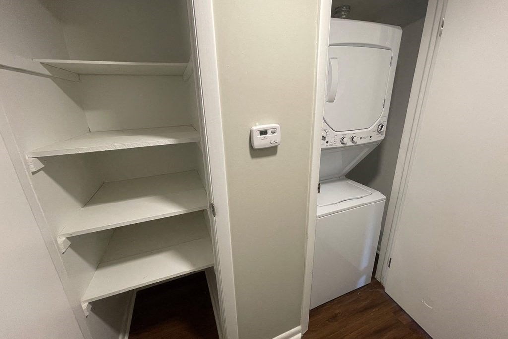a small closet with a washer and dryer in it