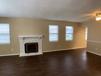 living room with wood floors and fireplace