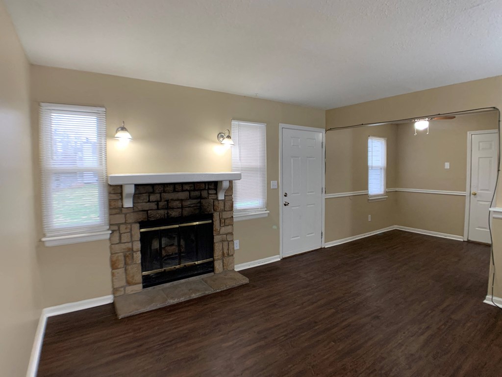 living room with wood floors and fireplace