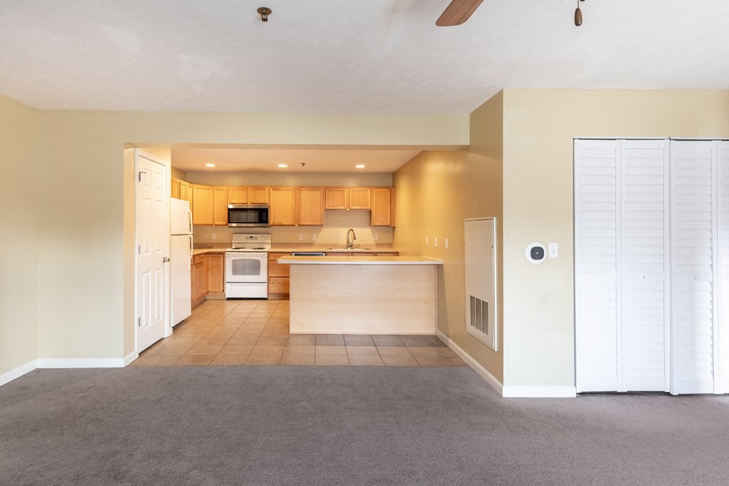 the living room and kitchen of an empty house