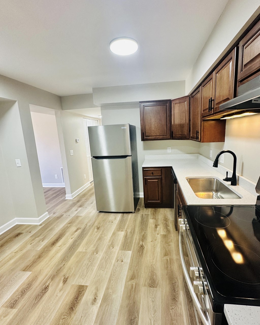 a kitchen with stainless steel appliances and wooden cabinets