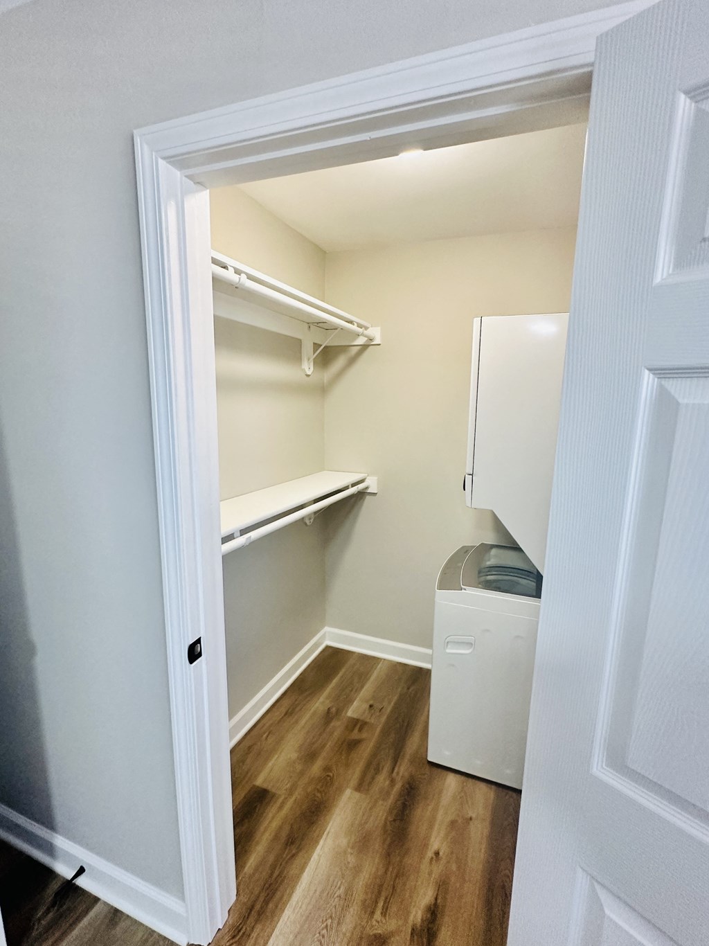 a room with a closet and a washer and dryer in it