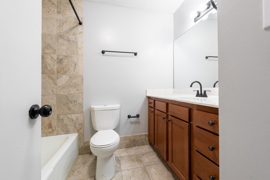 a bathroom with a toilet sink and bathtub