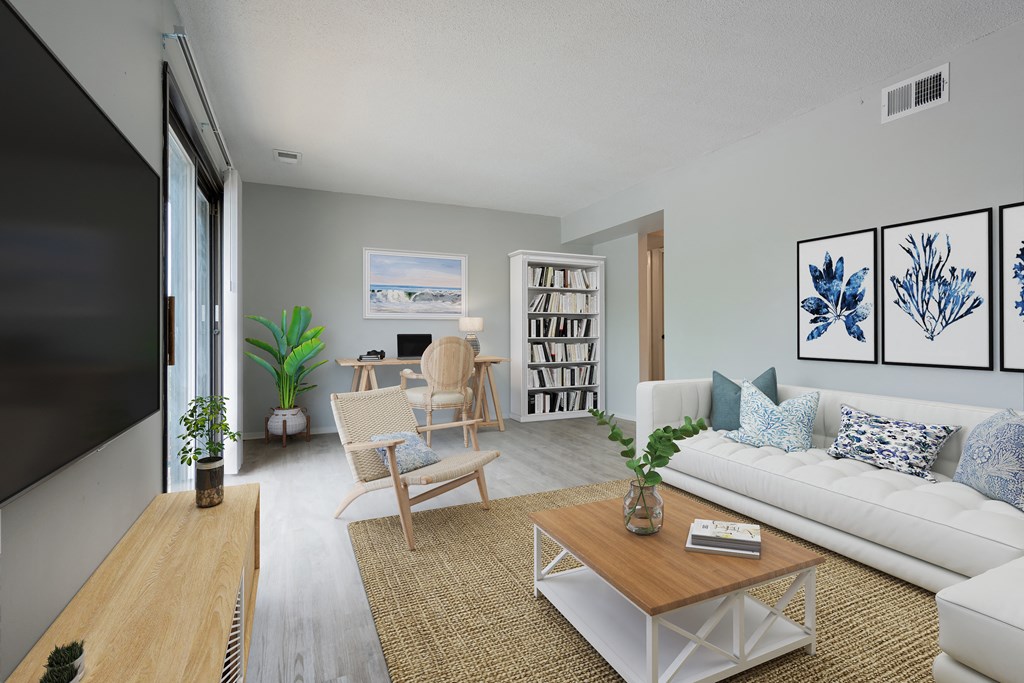 a living room with a white couch and a wooden coffee table