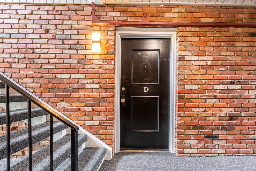 a black door with the letter d on it