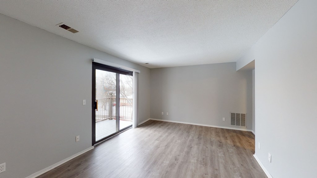 a bedroom with hardwood floors and grey walls