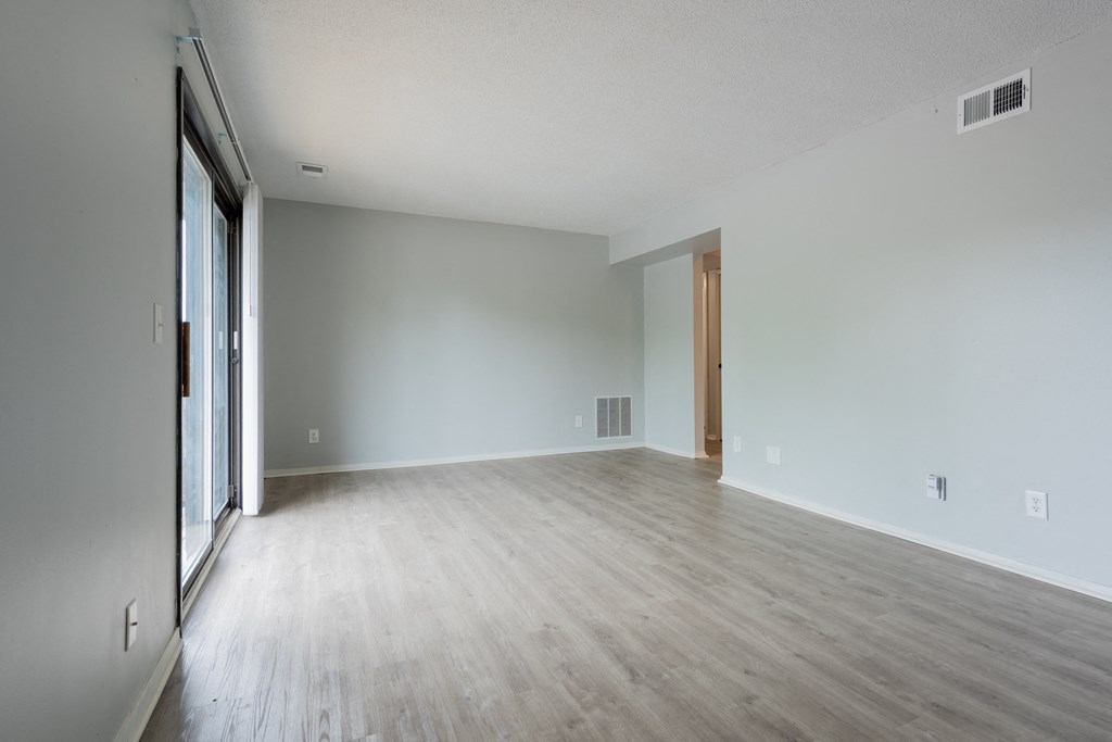 a bedroom with hardwood floors and grey walls
