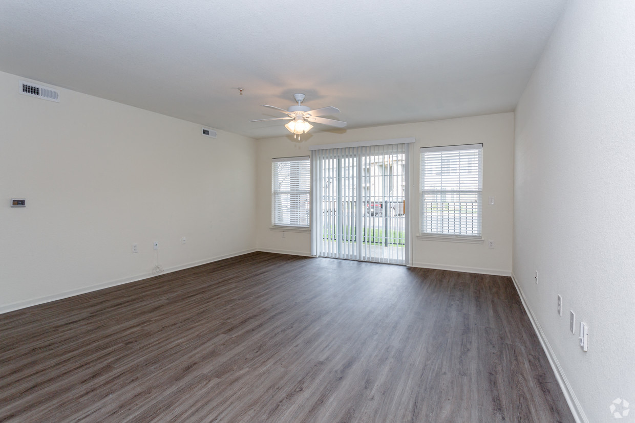 Living room with vinyl plank flooring and patio