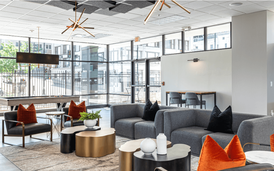 a living room with couches and chairs and tables