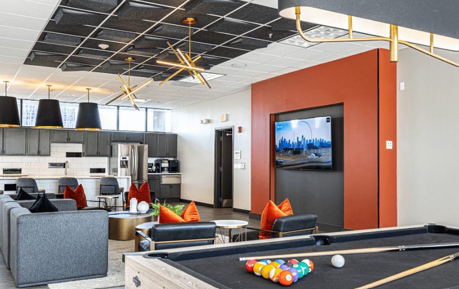 a living room with a pool table and a tv