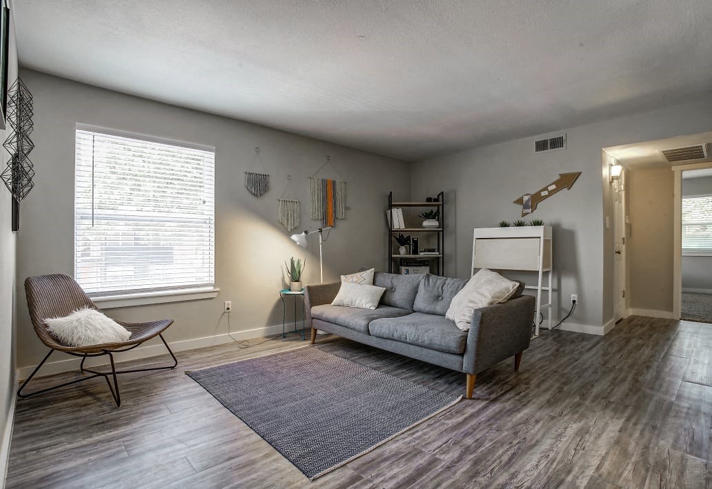 Image of living room with vinyl plank flooring, couch and table.