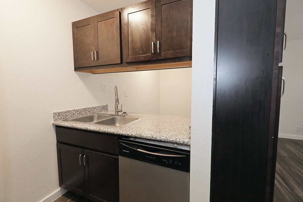a kitchen with a sink and a dishwasher at Bennett Ridge Apartments, Oklahoma City