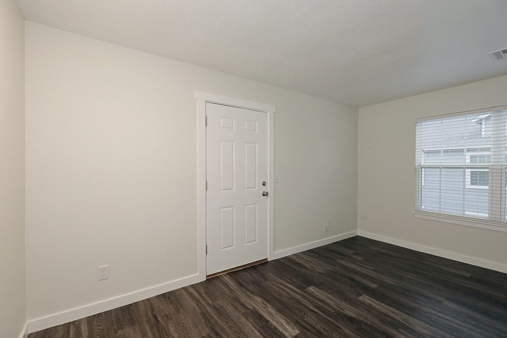 a bedroom with hardwood floors and white walls at Bennett Ridge Apartments, Oklahoma City, Oklahoma
