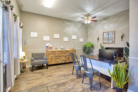 a living room with a desk and a tv