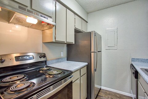 a kitchen with stainless steel appliances and a refrigerator