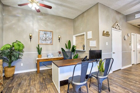 a home office with a desk and chairs and a computer