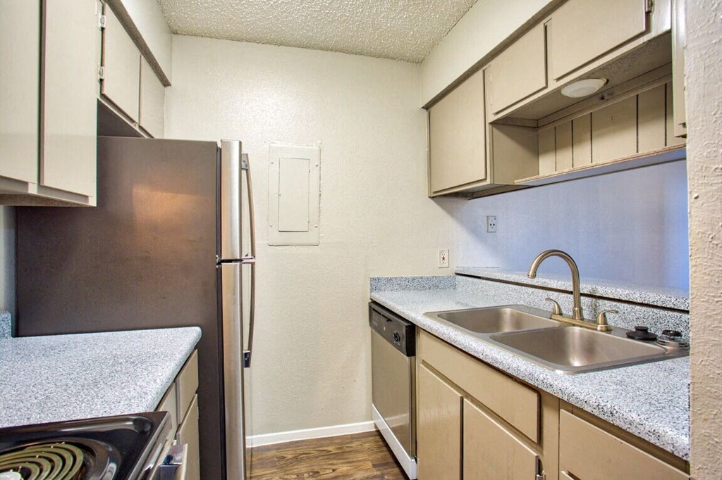 a kitchen with a sink and a refrigerator