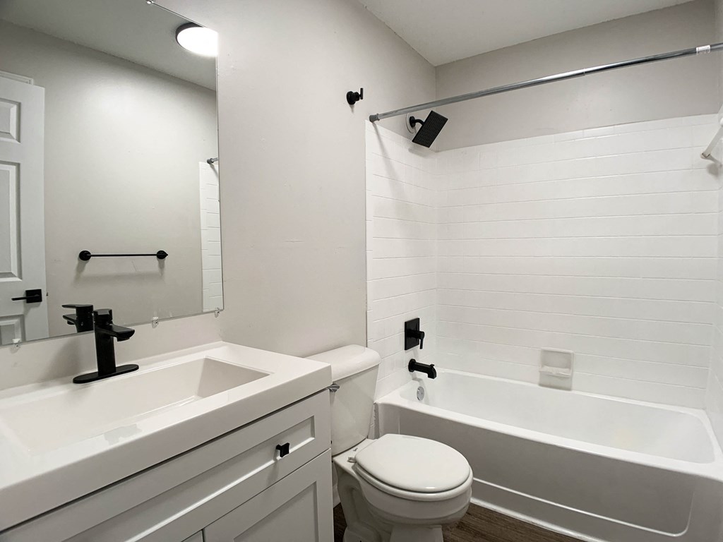 Photo of full sized bathroom with white countertops and bathtub in Kansas City.