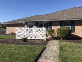 a house with a white fence in front of it