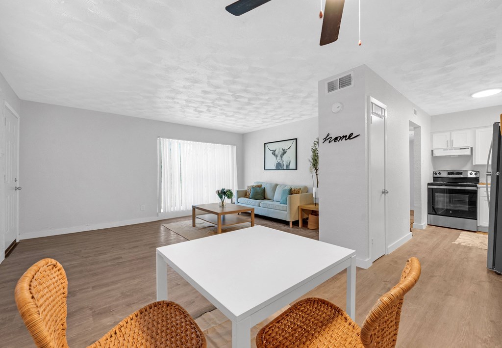 a living room with a white table and chairs