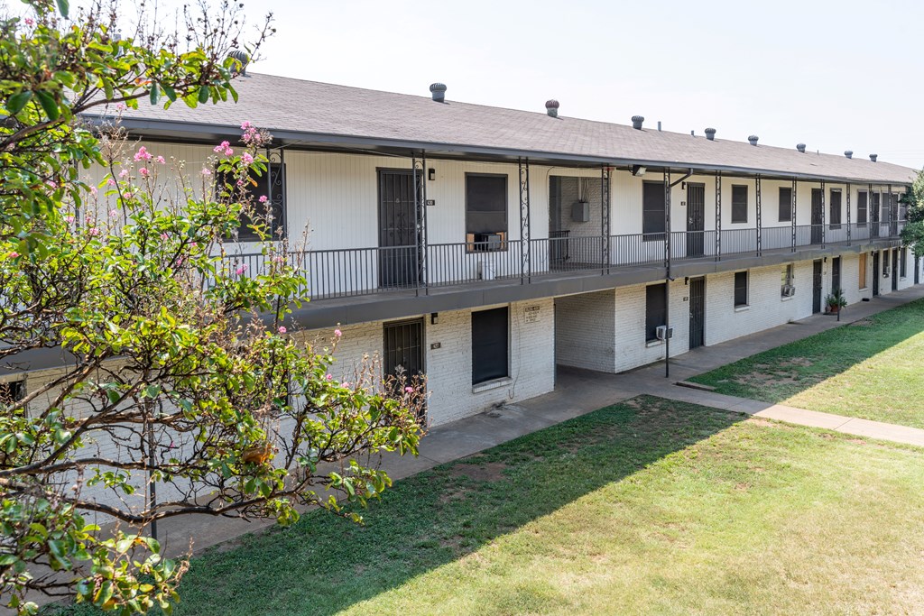 A long white building with balconies and windows.