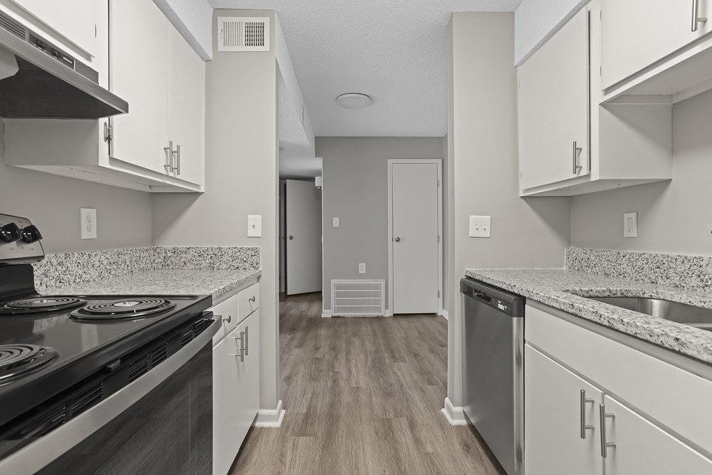 a kitchen with granite counter tops and stainless steel appliances