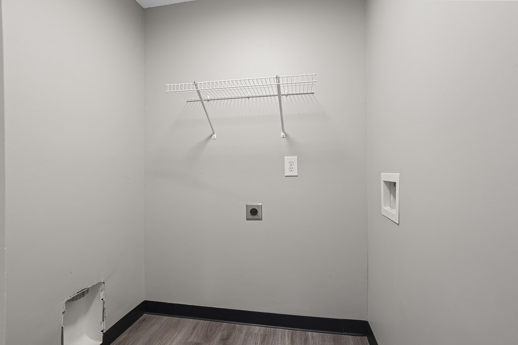 a white room with a wire rack on the wall