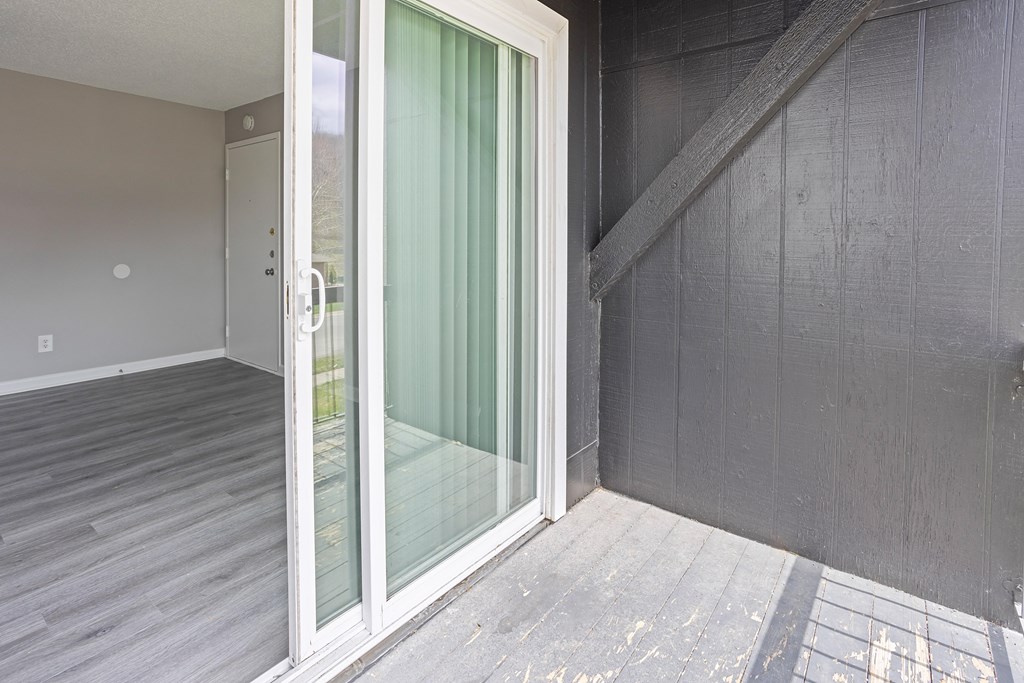 a sliding glass door in a room with a staircase