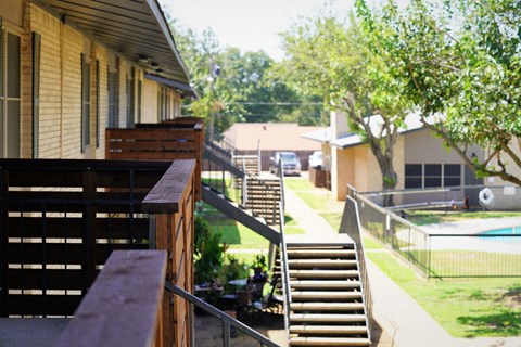 the backyard of a house with stairs and a pool