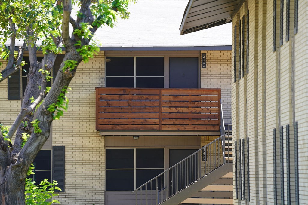 a wooden balcony on the side of a building