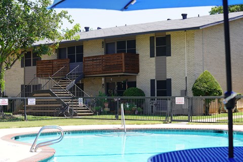 a swimming pool in front of an apartment building
