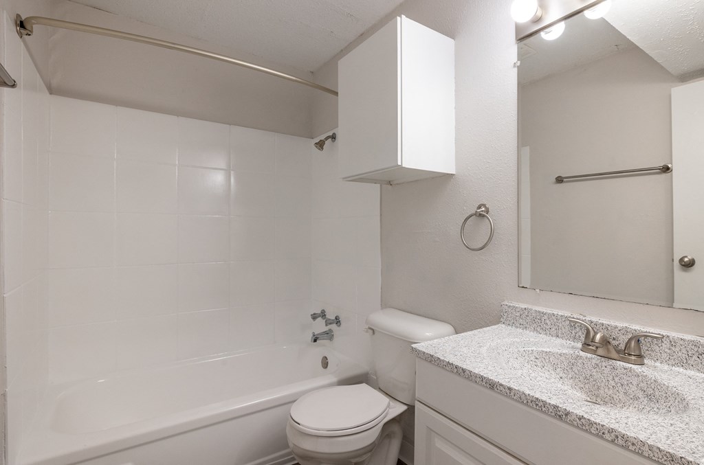 a bathroom with a sink toilet and bathtub